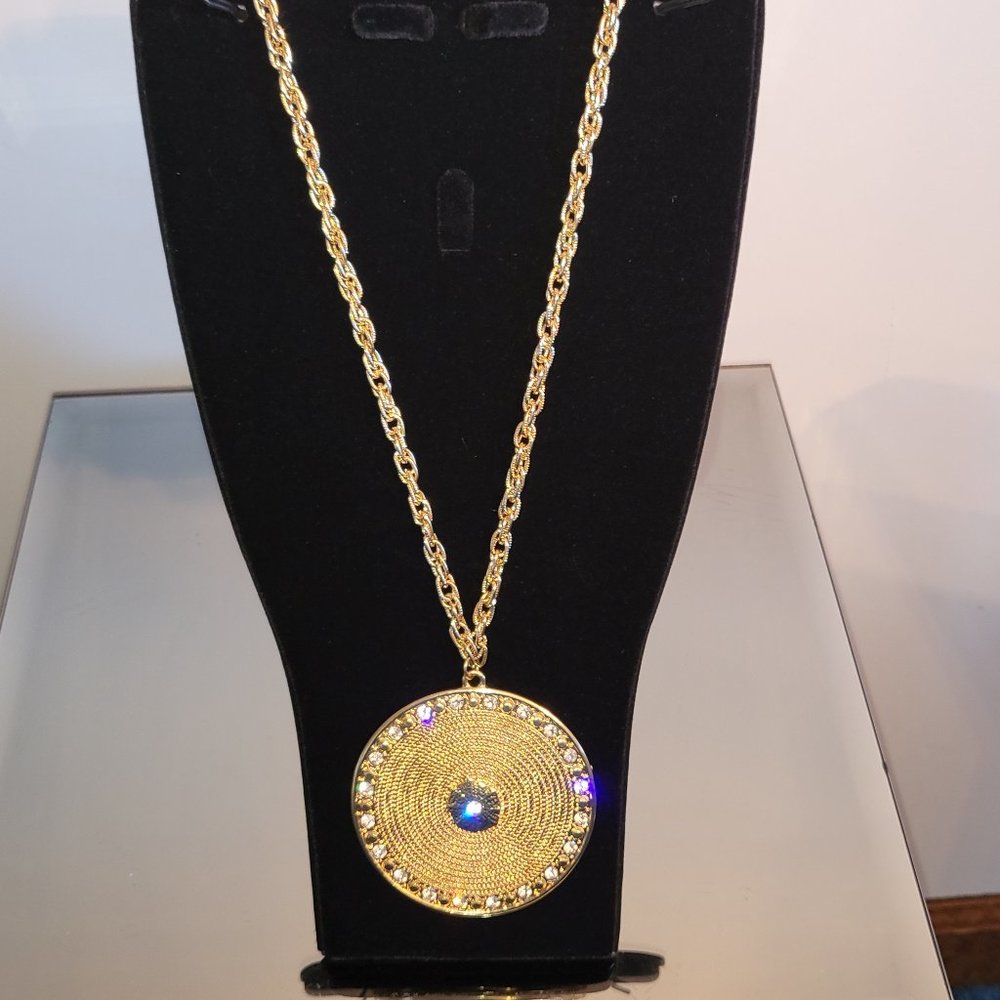 Gold-tone Neck with a 2" Textures Medallion Accented with Sparkling Stones